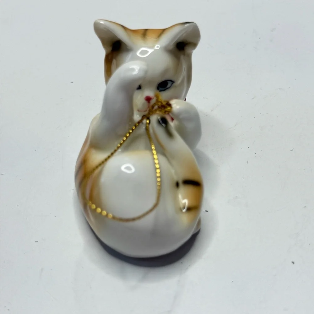 Decorative White and Tan Ceramic Cat Ornament with Red Bow